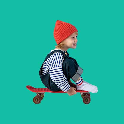 little girl sitting on a skateboard