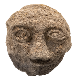 a crude face carved in stone face